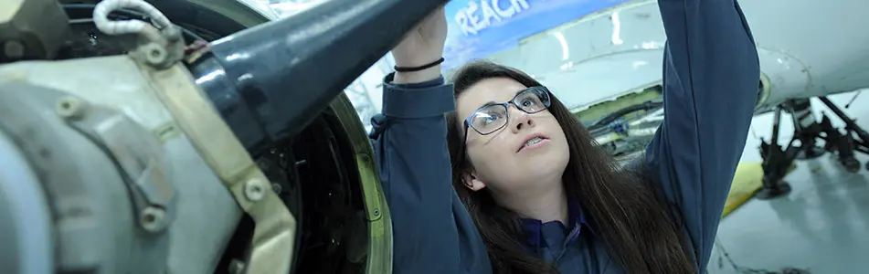 female aerospace engineer looking at a part